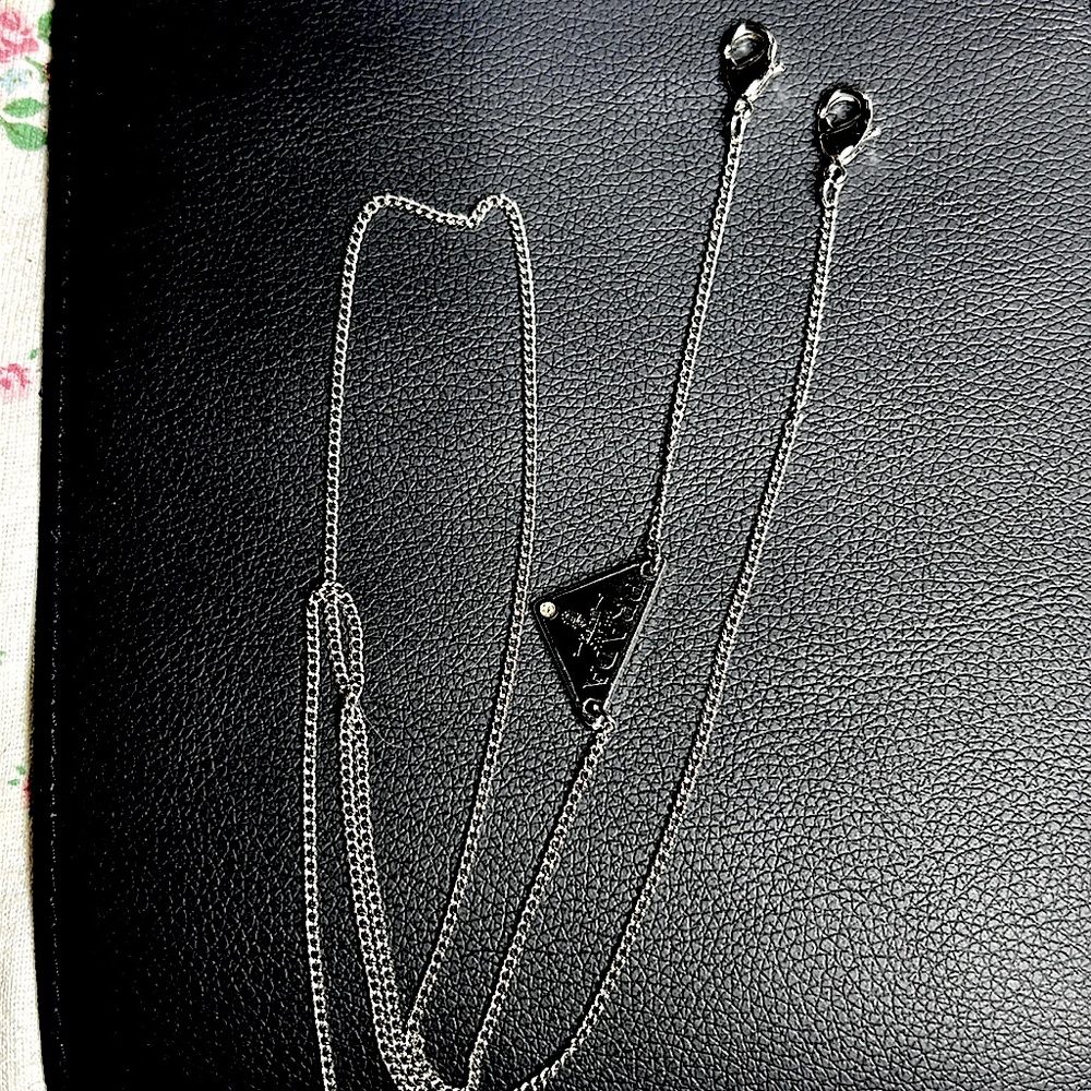 Prada logo glasses strap.
